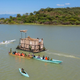 Asiwa the giraffe is gently moved toward safe land via barge.
